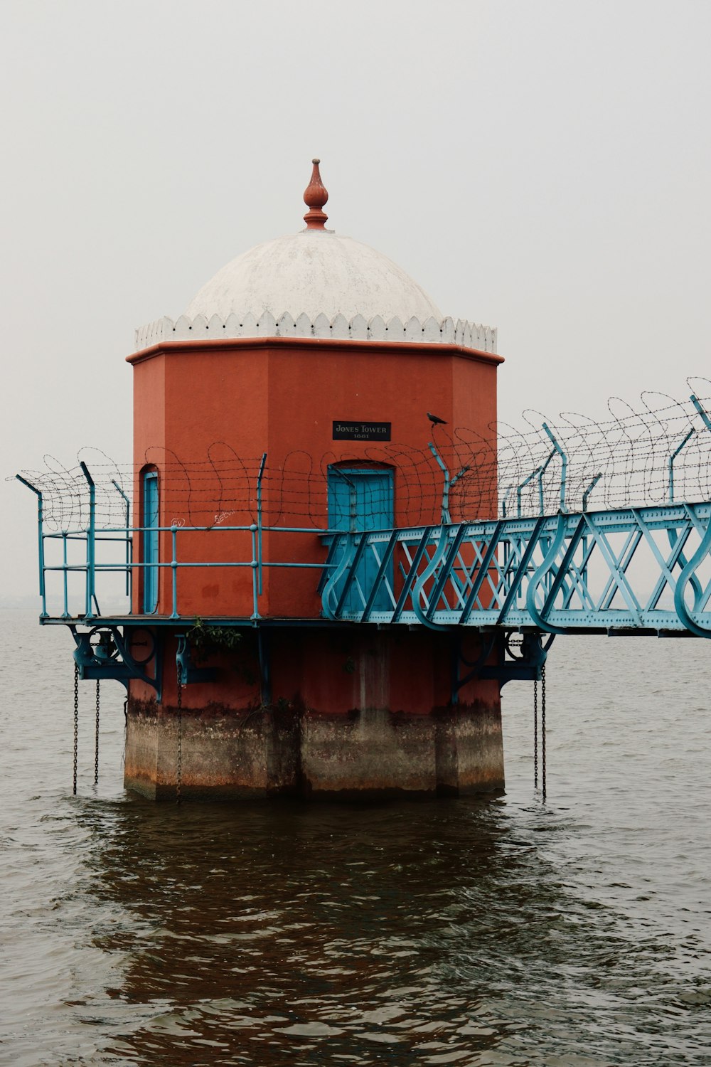 a red building with a blue railing on top of it