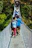 Group of trekkers crossing a wooden bridge surrounded by lush green jungle in Gunung Leuser National Park.