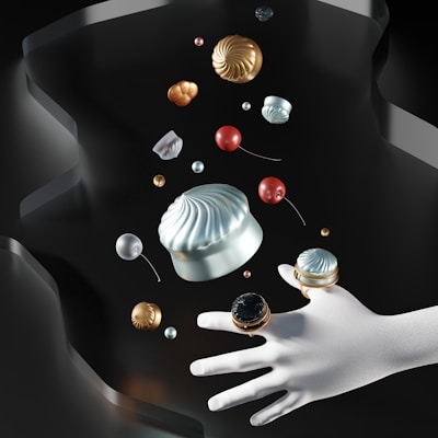 A surreal composition with a white mannequin hand adorned with ornate rings, surrounded by floating objects resembling colorful candies or orbs and ornate metallic decorations against a dark, abstract background.