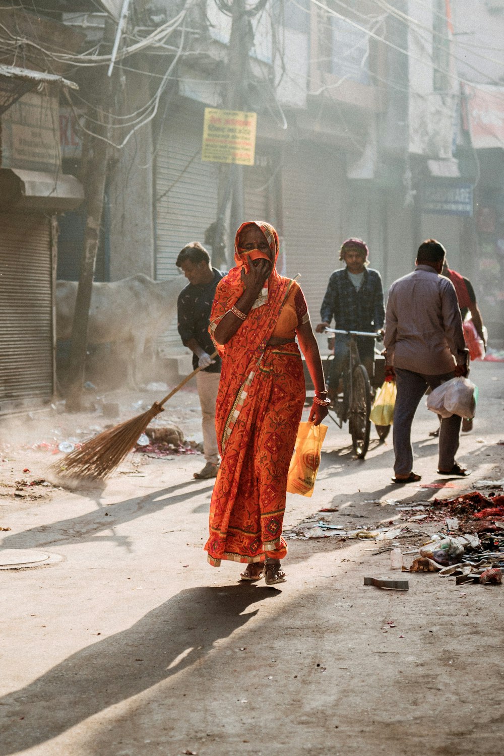 a woman walking down a street while talking on a cell phone