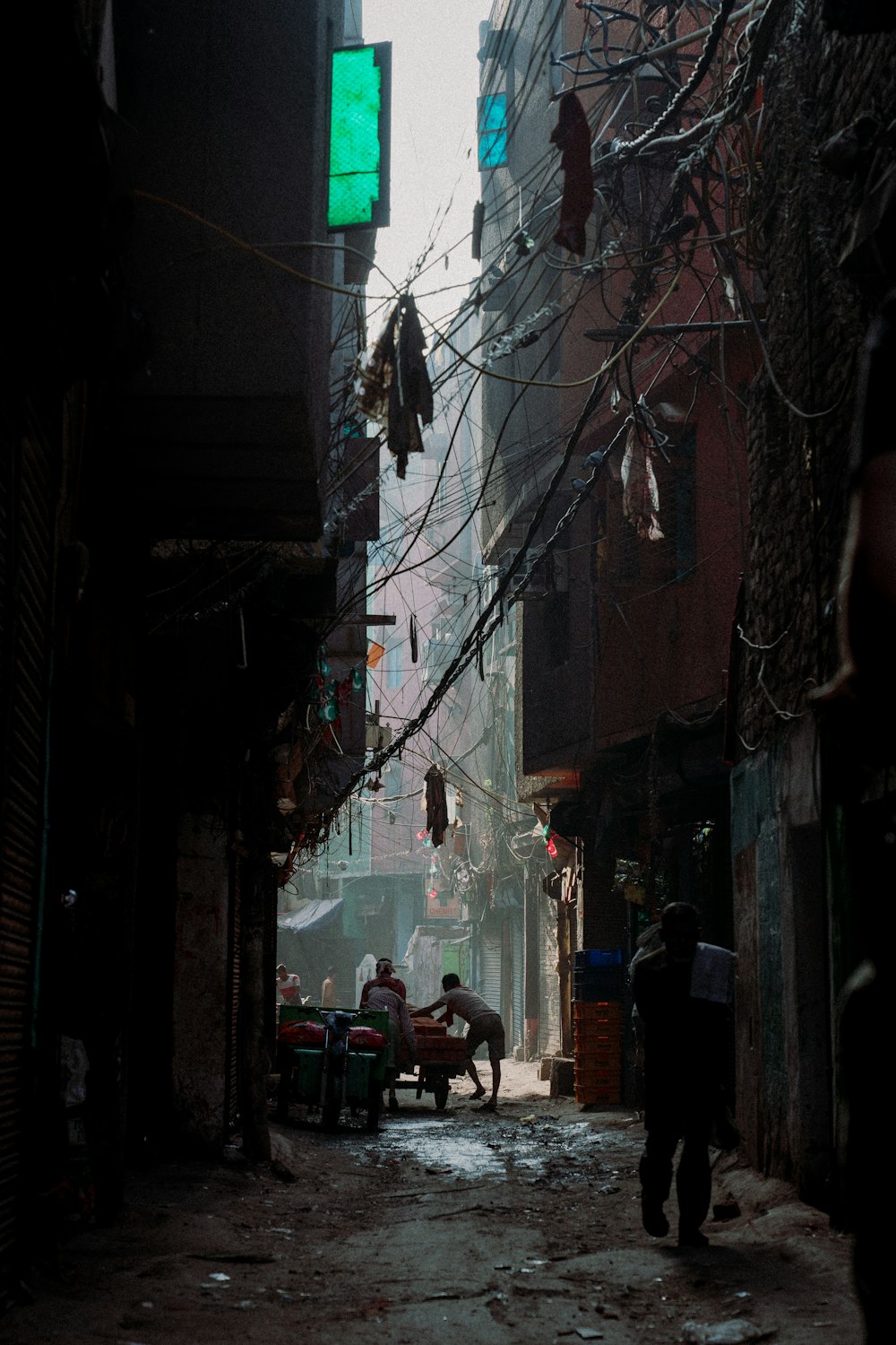 a man walking down a street next to tall buildings