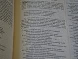 An open book displaying a passage from the Bible. The text is from the book of Jeremiah, chapter 15, describing God's words to the prophet about the fate of the people who have turned away. The verses are printed in a clear, readable font with chapter and verse numbers highlighted for easy reference.