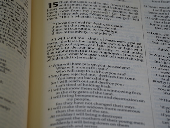 An open book displaying a passage from the Bible. The text is from the book of Jeremiah, chapter 15, describing God's words to the prophet about the fate of the people who have turned away. The verses are printed in a clear, readable font with chapter and verse numbers highlighted for easy reference.