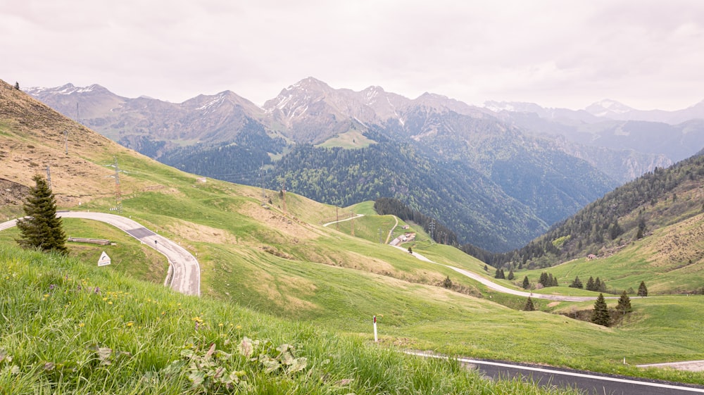 a scenic view of a winding road in the mountains