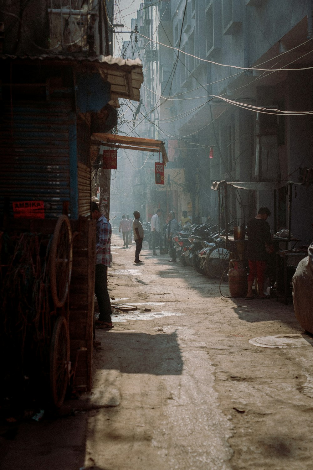 a man walking down a street next to tall buildings