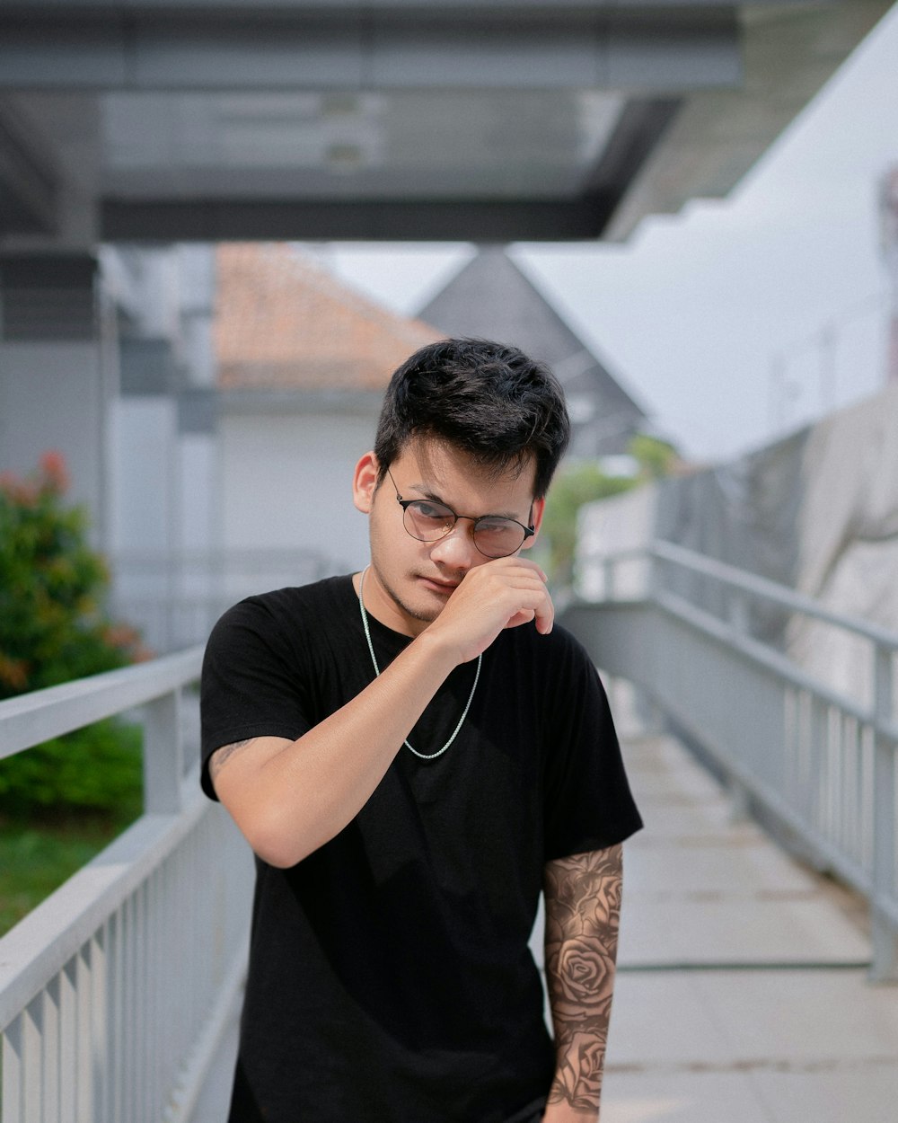 a young man with a black shirt and a pair of glasses