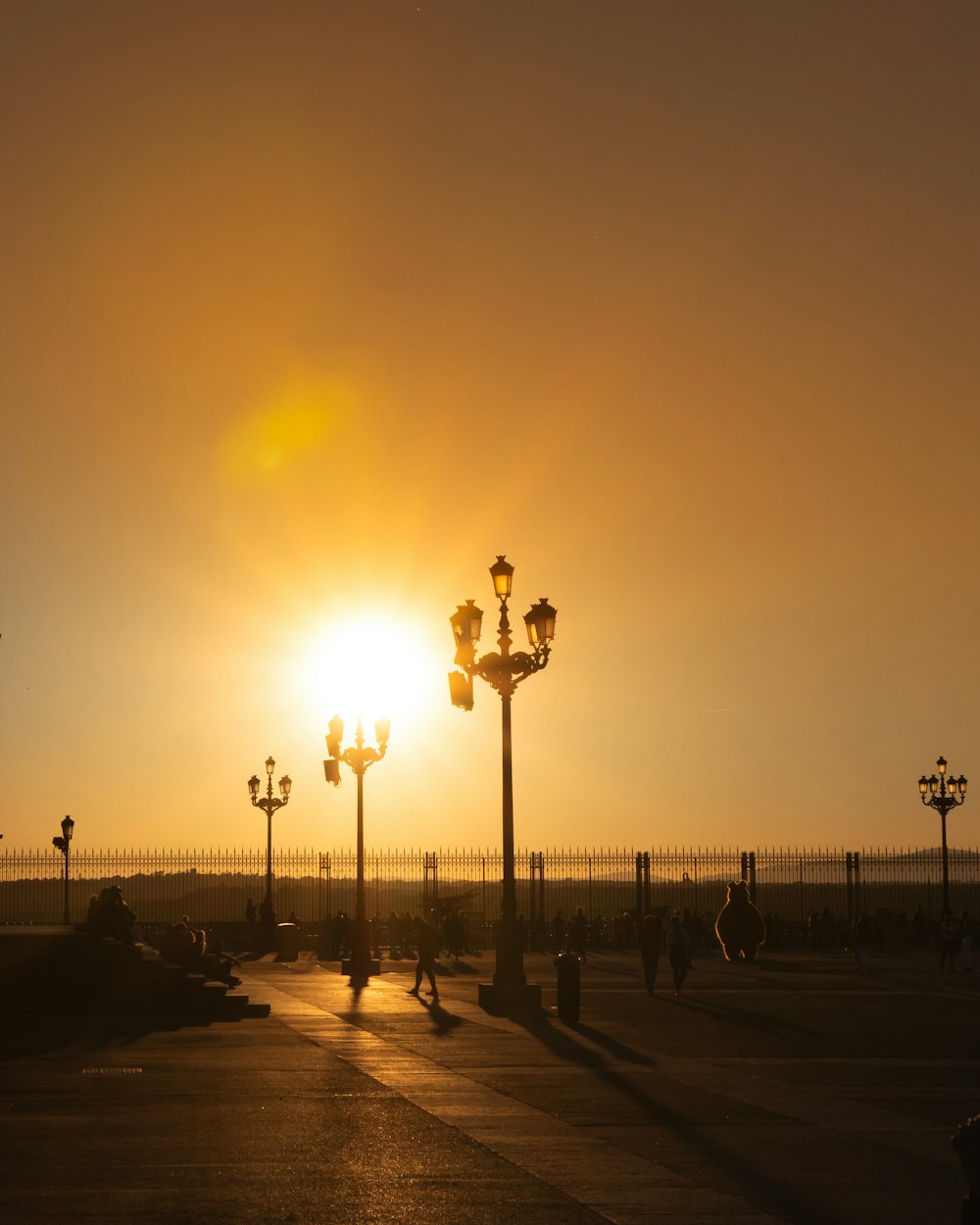 the sun is setting over a city street