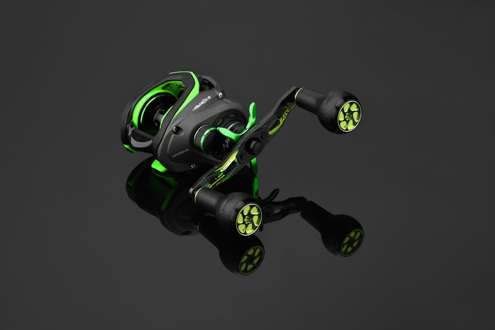 a close up of a fishing reel on a black background