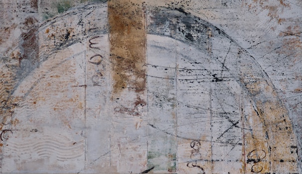 A textured mixed media piece combining weathered clay tones with charcoal and graphite accents.