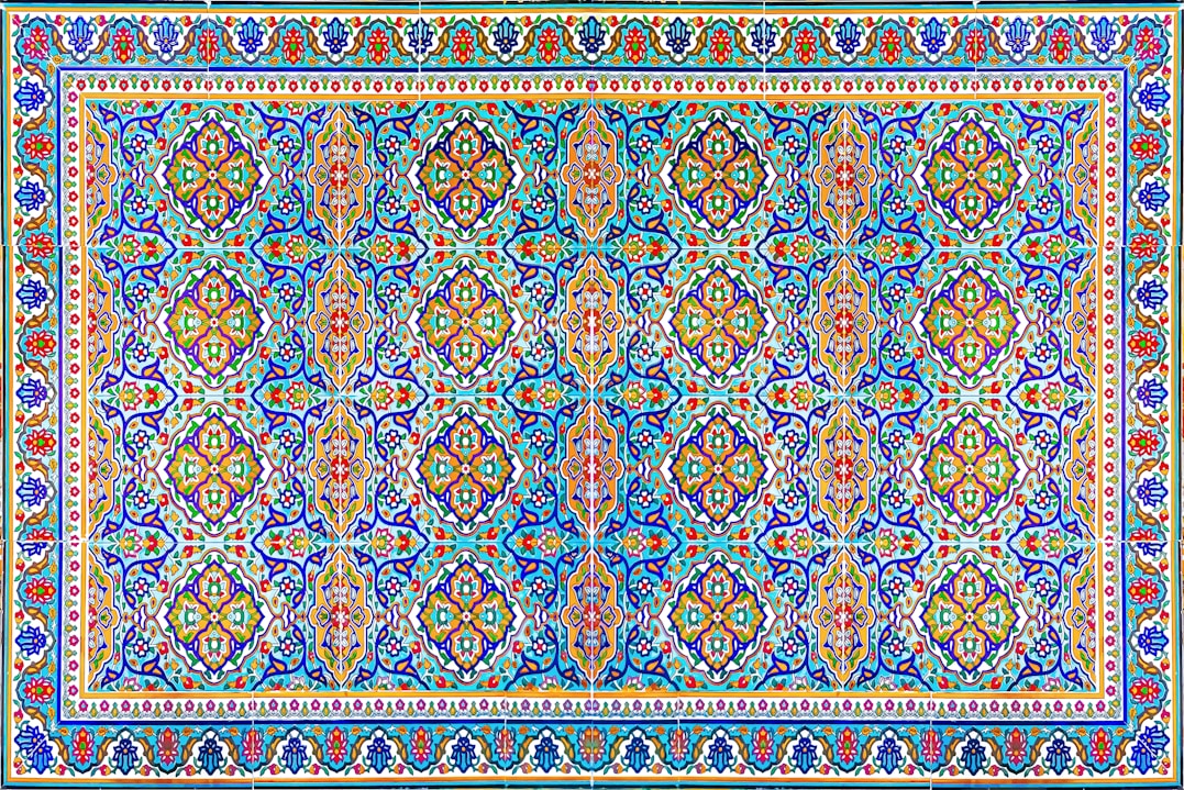 a blue and red rug with an intricate design