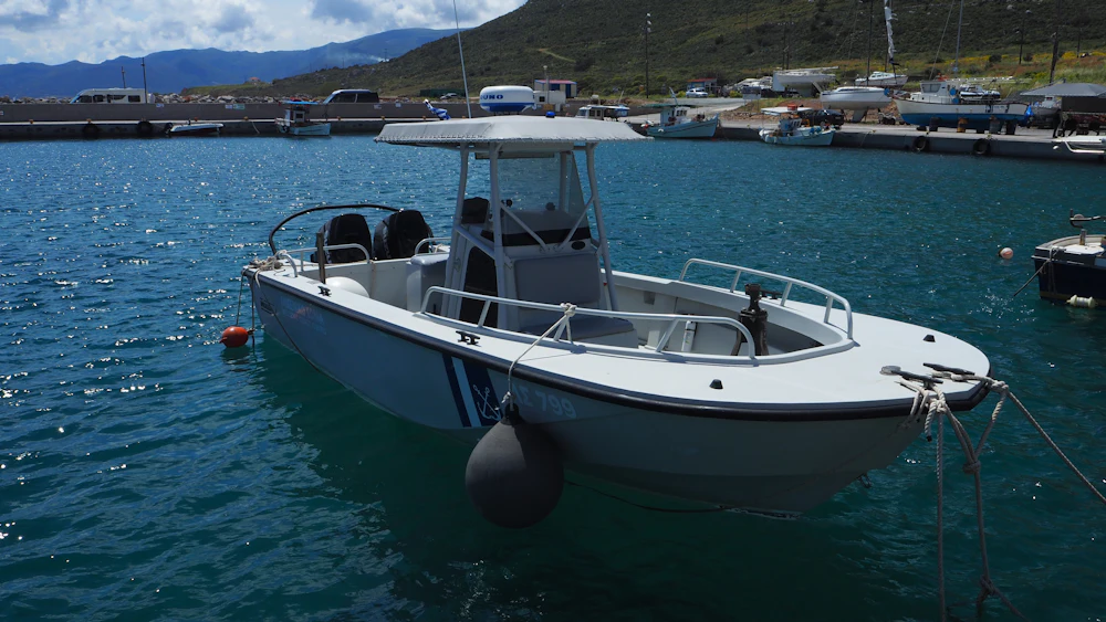 A center console boat tied up along a marina dock