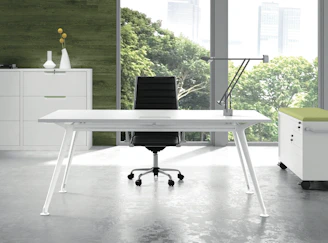 a white desk with a black chair in a room