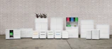 a group of white cabinets sitting next to a brick wall