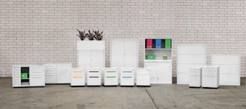 a group of white cabinets sitting next to a brick wall