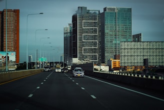 A collage showing an airplane soaring, a bus on a highway, a speeding train, and a cargo truck on the road.
