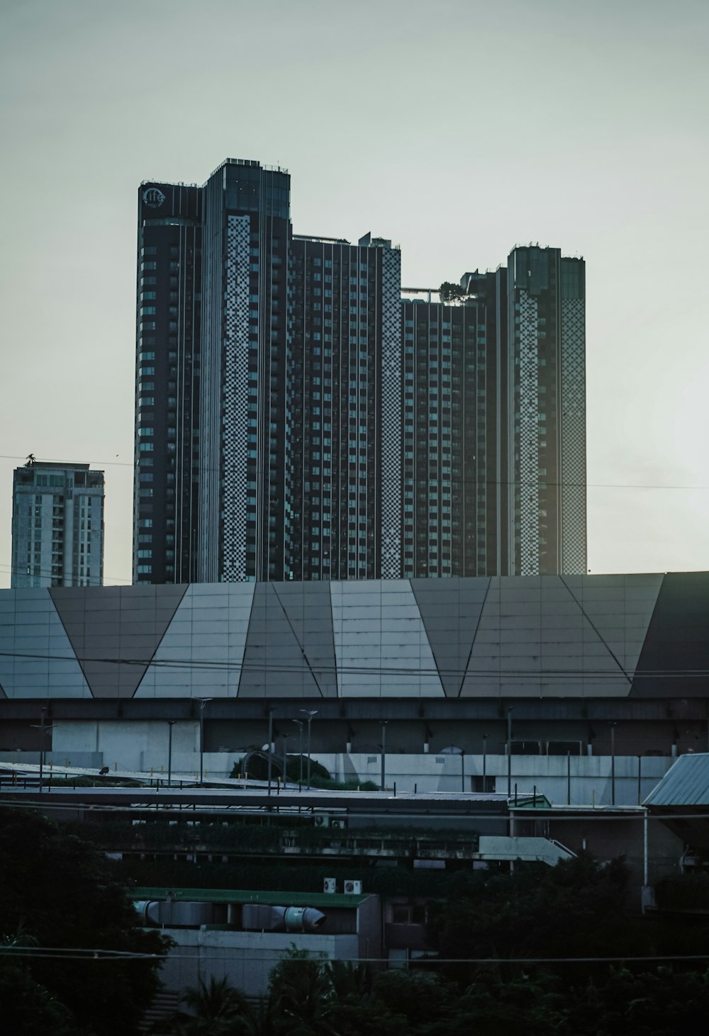 a large building with a lot of tall buildings in the background