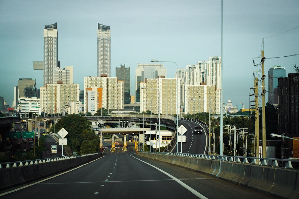 a city with tall buildings and a bridge