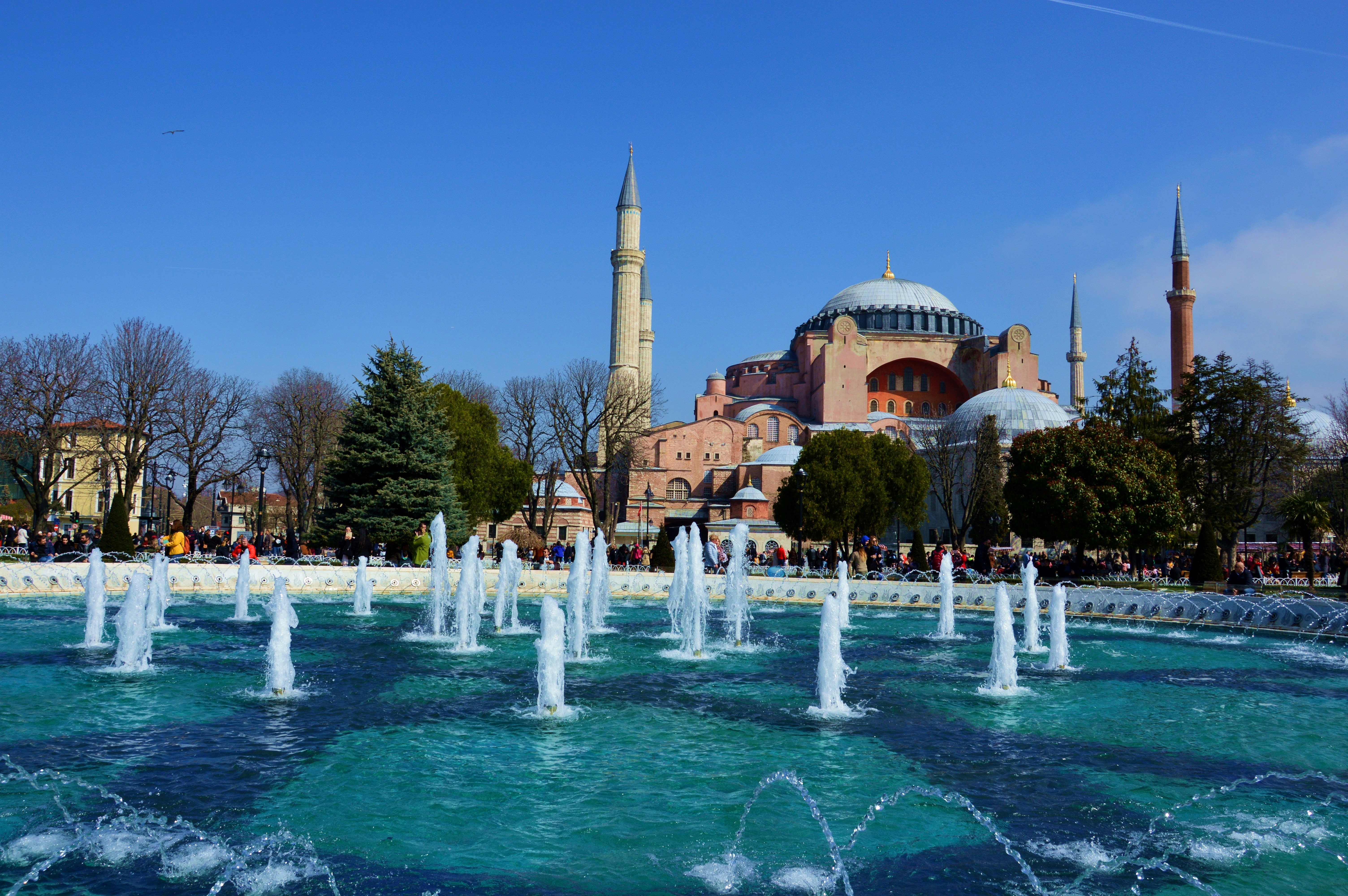 a large building with a fountain in front of it