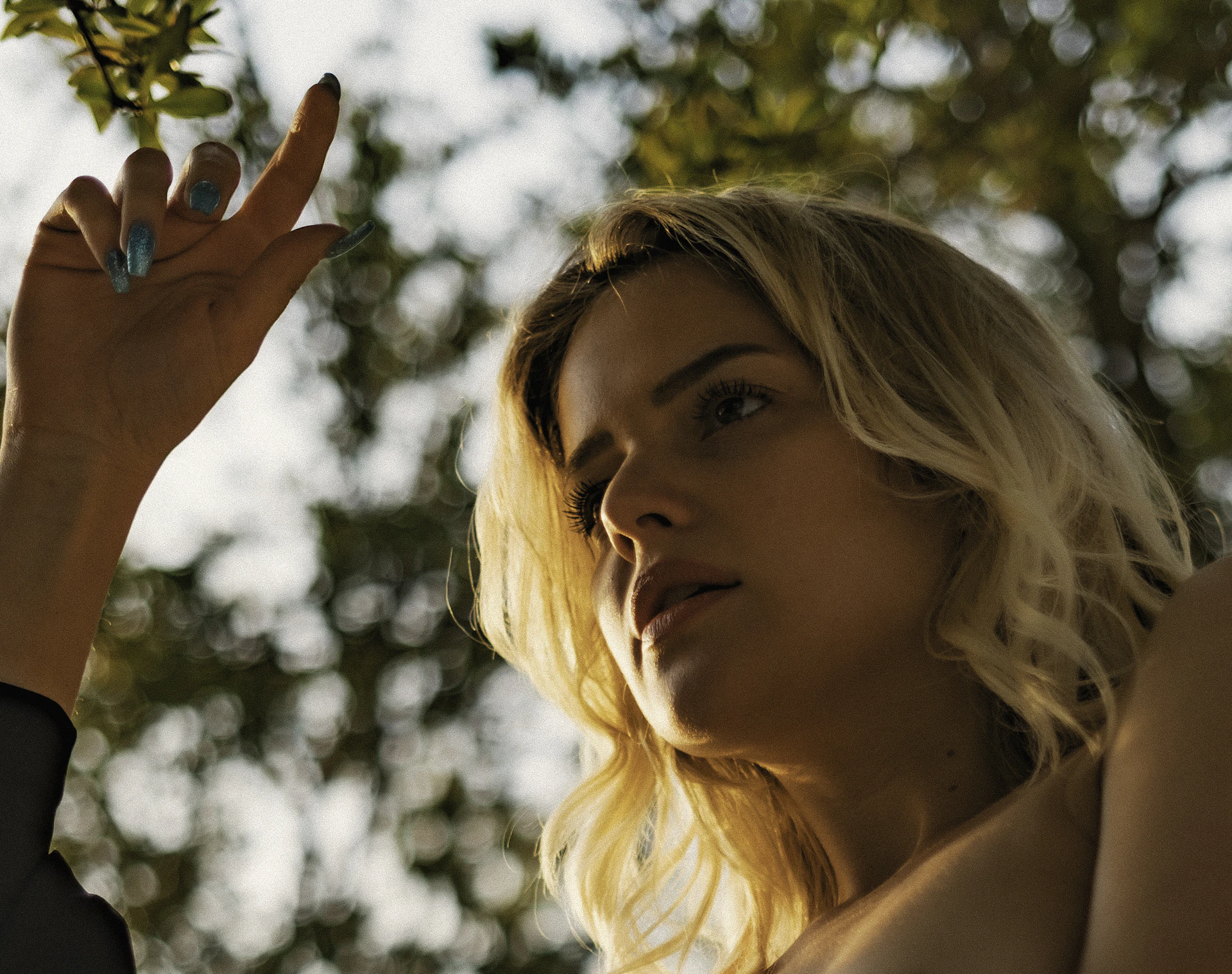 a woman holding a plant up to her face