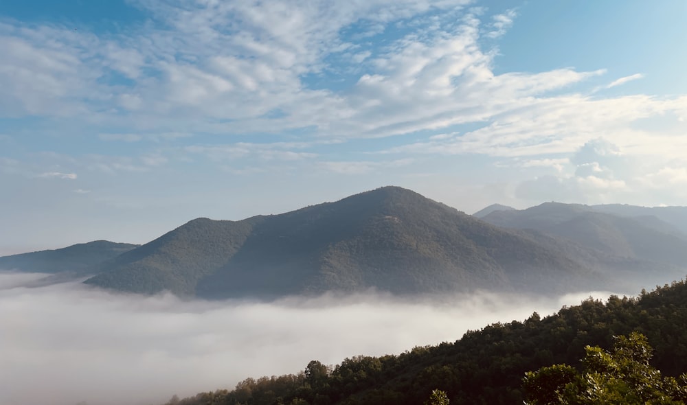 a view of a mountain with low lying clouds