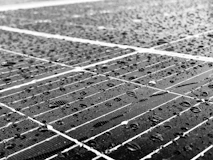Close-up of solar panel surface with water droplets repelled by nano coating