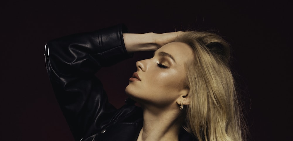 a woman in a leather jacket posing for a picture