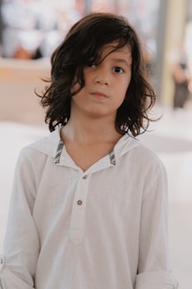 a little girl with a white shirt and a black and white tie