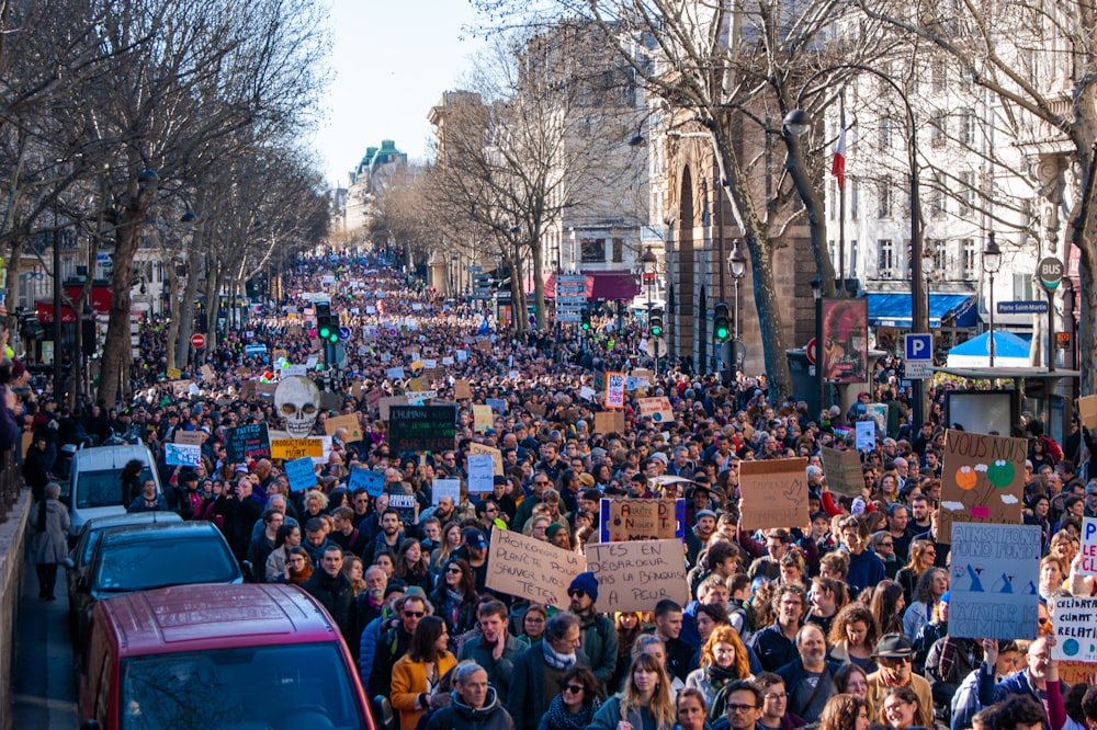 a large group of people walking down a street