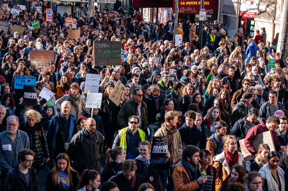 a large group of people walking down a street