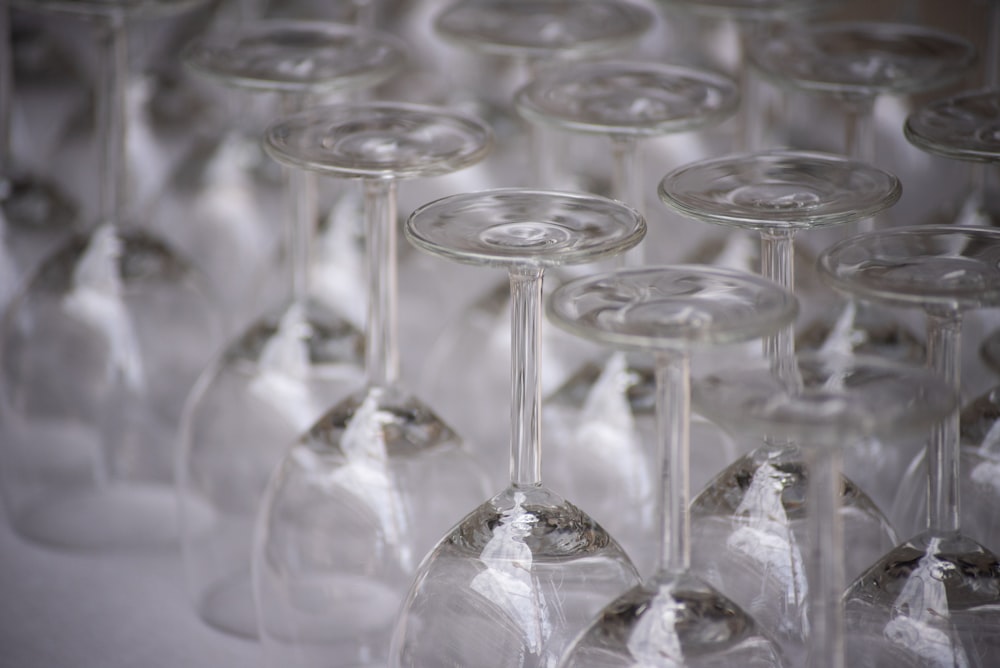 a bunch of wine glasses that are lined up