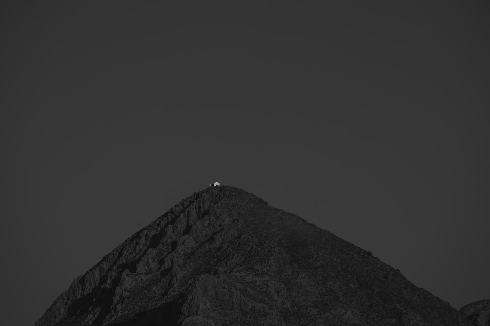 a black and white photo of a mountain peak