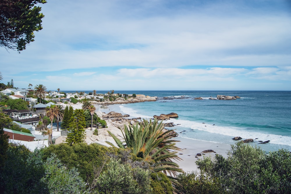 a view of a beach from a hill overlooking the ocean