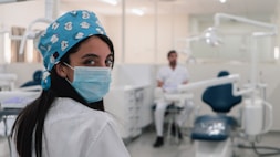 A professional portrait of Dr. Ville Kemilä in a dental office setting.