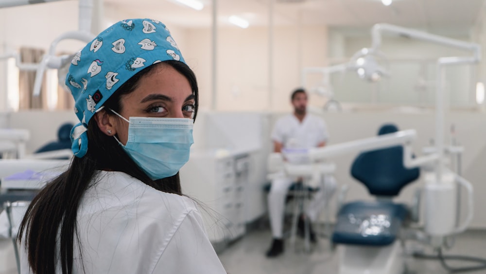 a woman wearing a surgical mask in a hospital