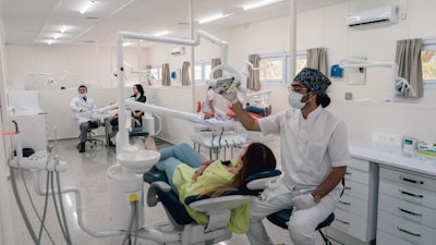 a dentist examines a patient's teeth in a dental office