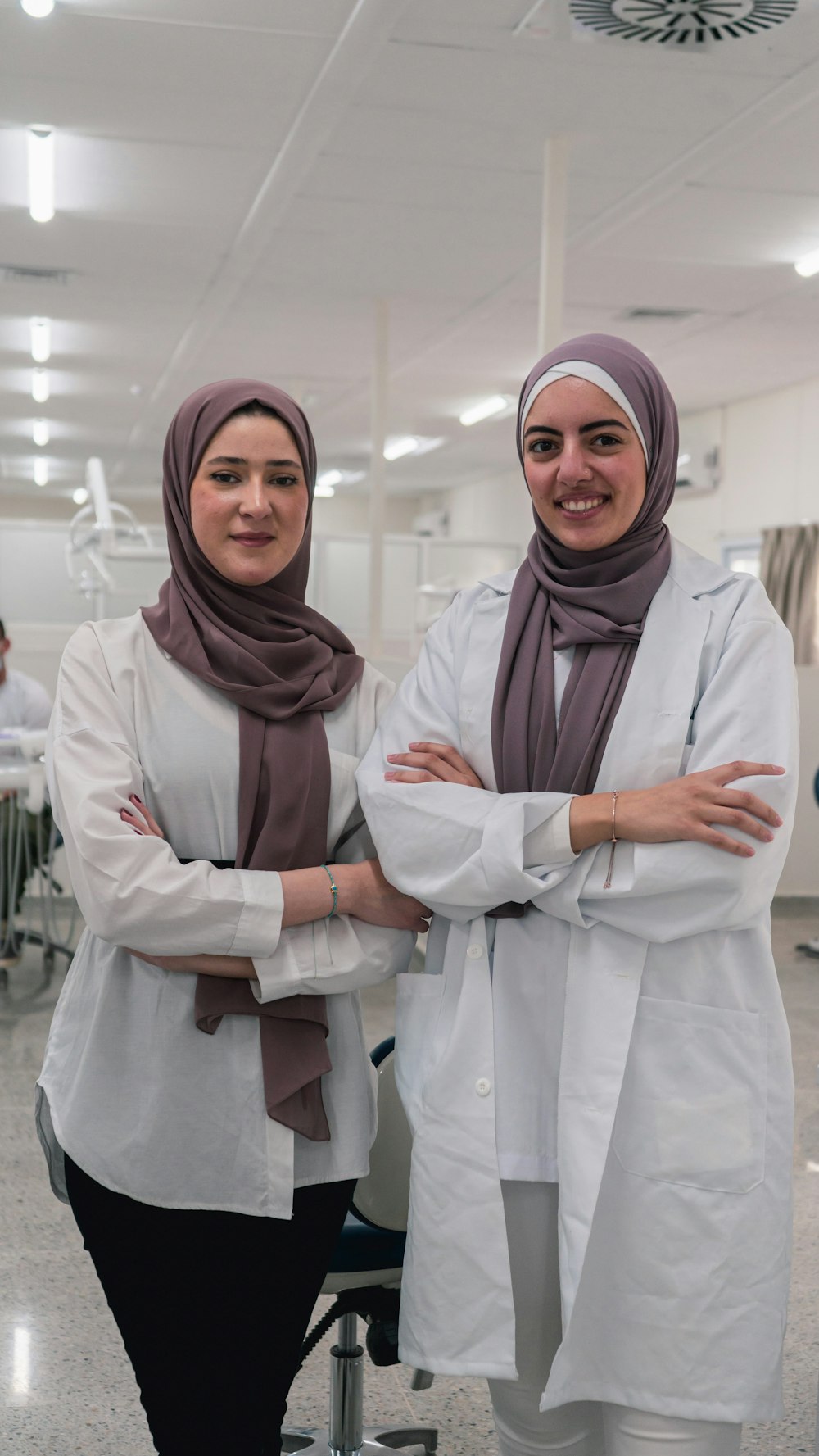 two women in hijabs standing next to each other