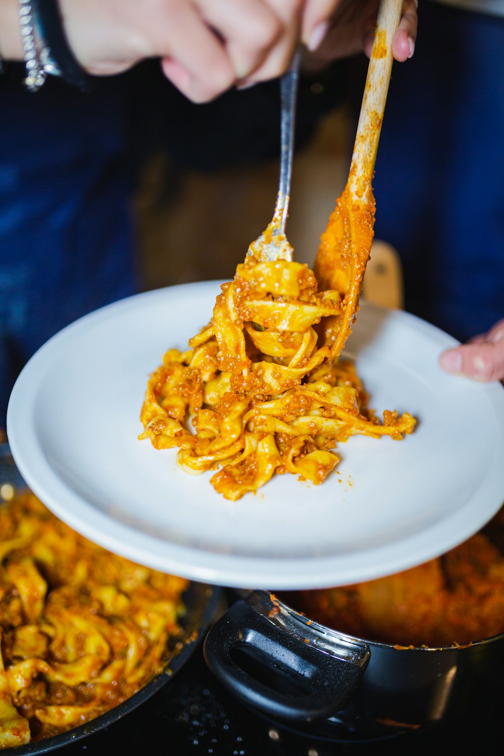 a person holding a spoon full of food