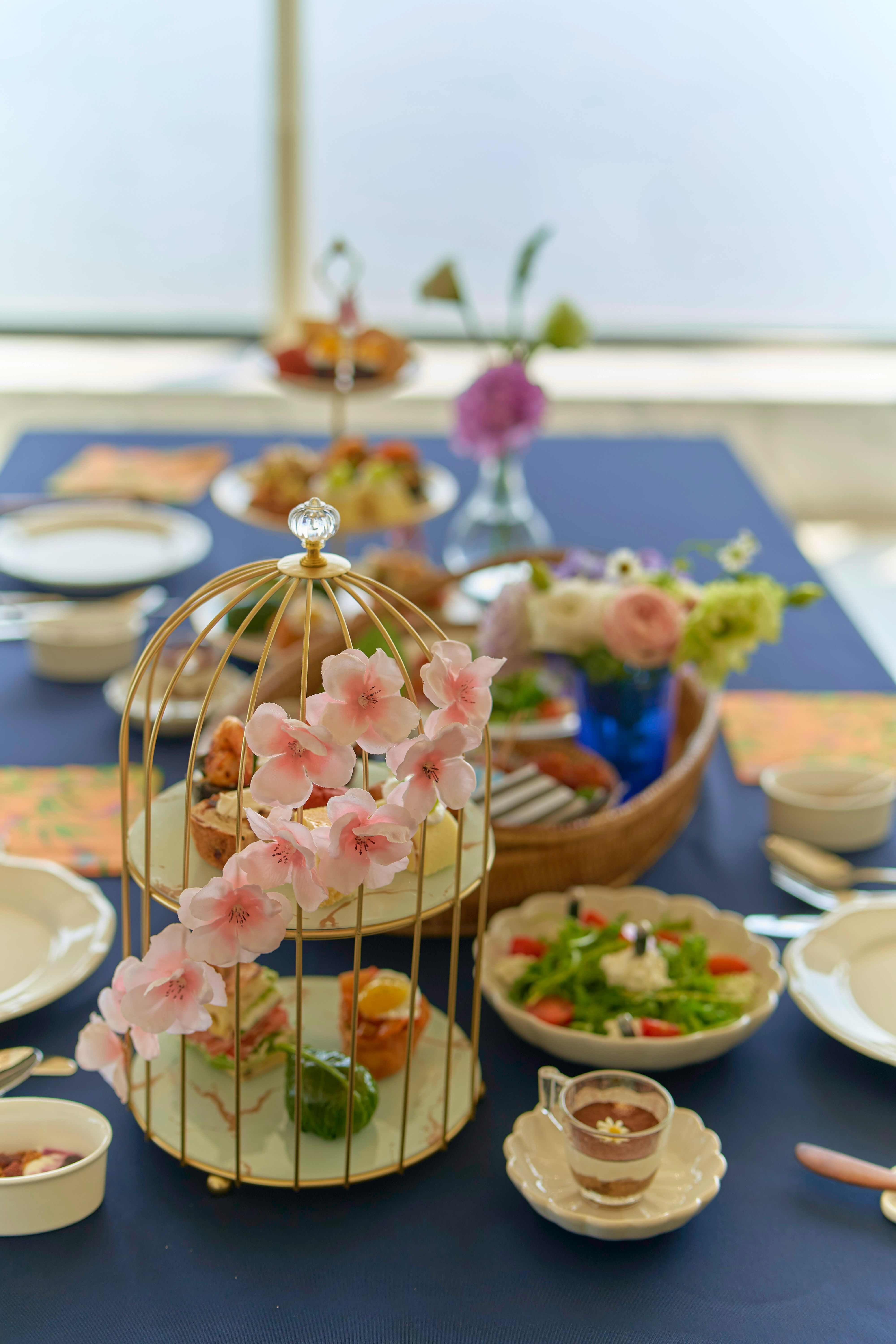 Birdcage filled with flowers on a table