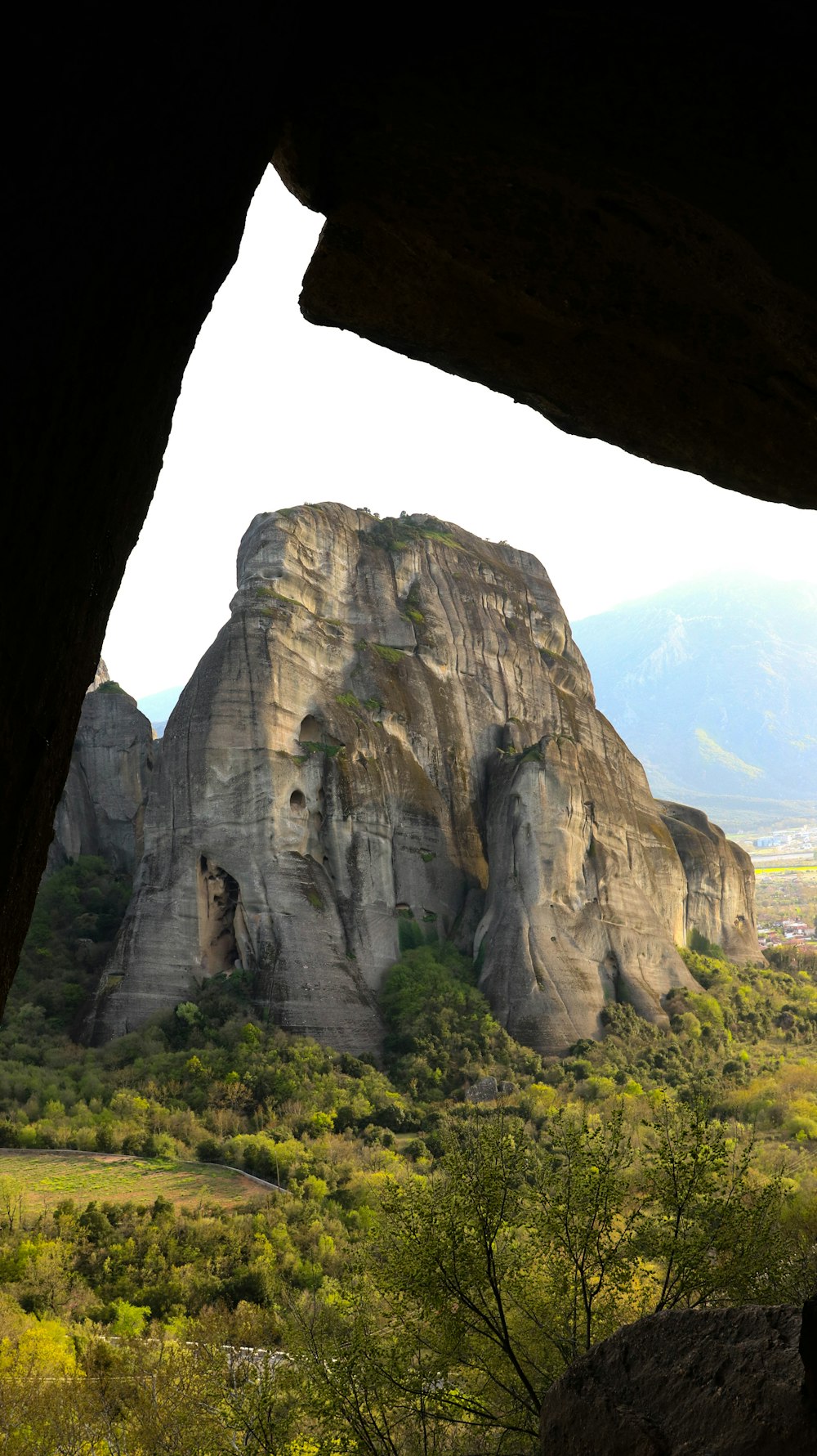 a view of a rocky mountain from inside a cave