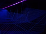 A glowing neural grid with intersecting lines and nodes pulsating softly in blue and purple hues
