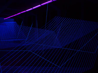 Close-up of neural grid background with thin luminous borders in cyan and violet accents.