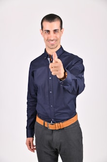 Headshot of a young South Asian man with a friendly smile, wearing a casual shirt.