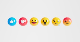 a row of different colored eggs with faces painted on them