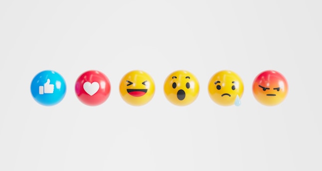 a row of different colored eggs with faces painted on them
