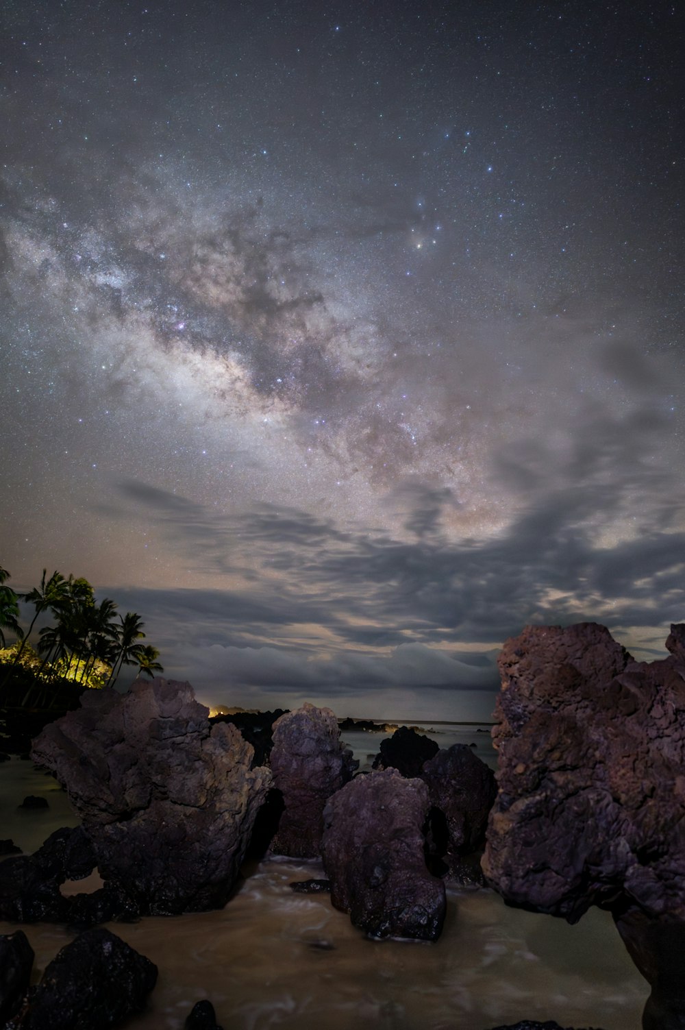 the night sky is filled with stars and clouds