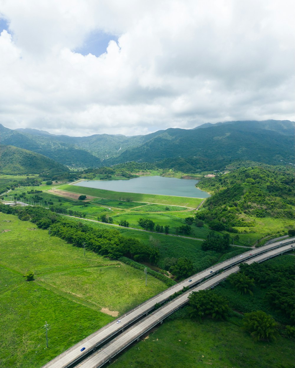an aerial view of a highway and a lake