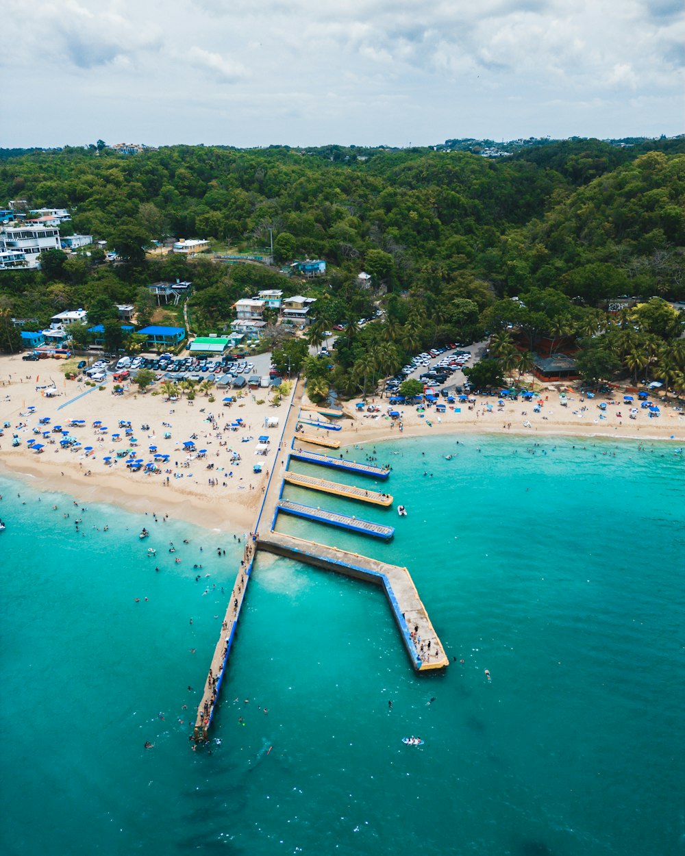 an aerial view of a beach with a pier