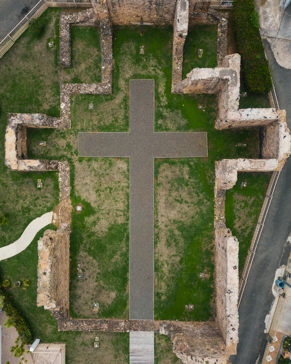 an aerial view of a large cross in the middle of a field