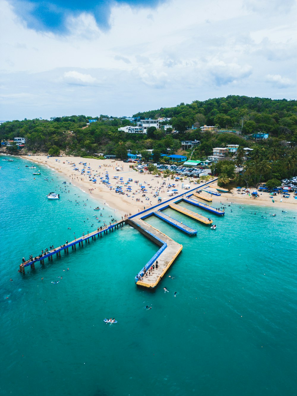 an aerial view of a beach and pier