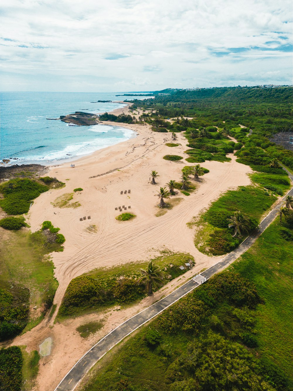 an aerial view of a sandy beach and ocean